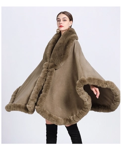 Detail of soft faux rabbit fur collar and cuffs on a brown oversized knit shawl cape
