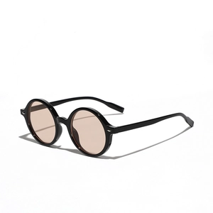 Retro oversized round black frame sunglasses with light tea lenses on white background