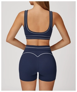 Detail view of navy blue yoga set with white contrast stitching and heart-shaped back seams