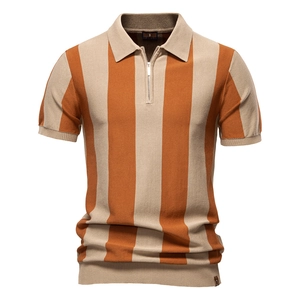 Detailed close-up of orange and beige striped knitted polo shirt with metal zipper