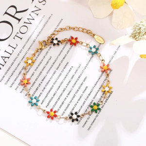Close-up of stainless steel chain bracelet with colorful enamel daisy charms and lobster clasp