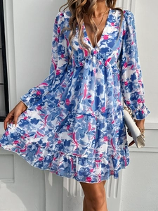 Detail of elegant V-neck floral dress with blue and pink prints and ruffled sleeve cuffs