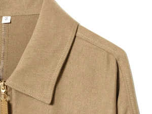 Detail view of khaki jacket neckline and shoulder stitching with size S label