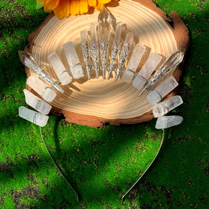 Detail of handmade clear quartz crystal crown with silver wire wrap on natural wood base