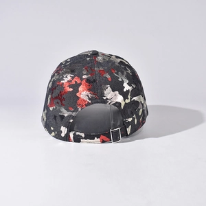 Detail of silver metal buckle and red camo print on a structured baseball cap