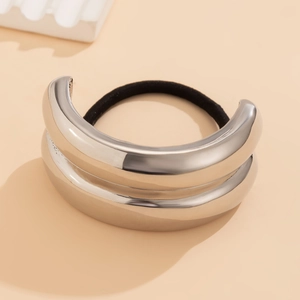 Detail of silver metallic double-layered ponytail cuff with a sleek mirrored finish