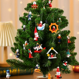 Assorted wooden Christmas tree ornaments with Santa and snowman on a festive pine branch