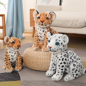 Detail showing plush snow leopard and spotted leopard toys in a cozy home setting