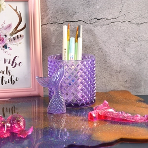 Macro detail of purple resin diamond pattern organizer with sparkly mermaid tail charms