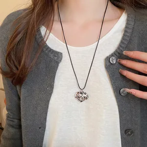 Wax rope necklace featuring a heart-shaped leopard print pendant with minimalist black cord