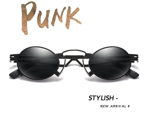 Macro shot of stylish black oval punk sunglasses with vintage matte metal frame finish