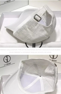 Detail of white woven baseball cap showing metal adjustment buckle and inner lining