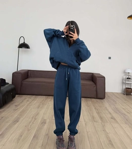 Detail of blue two-piece tracksuit set with thick knit fabric and drawstring sweatpants