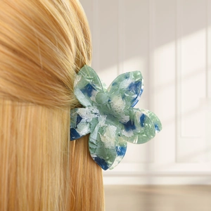 Detail of blue marble floral hair claw clip worn on blonde hair for a secure hold