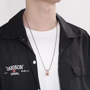 Close-up of hip-hop style layered pendant necklace with silver and rose gold finish