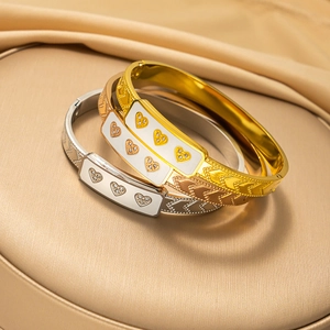 Three-piece stainless steel heart bracelets in gold, rose gold, and silver finishes