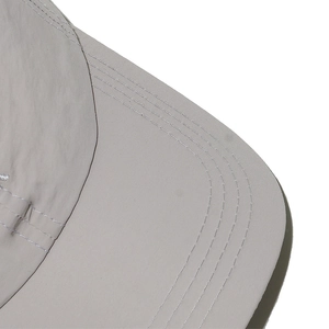 Detailed close-up of quick-dry baseball cap brim with durable reinforced stitching