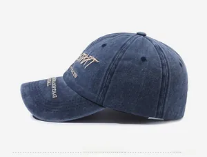 Close-up of vintage navy washed cotton baseball cap with white letter embroidery details