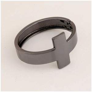 Macro detail of gunmetal cross bracelet showing the hinge mechanism and smooth finish