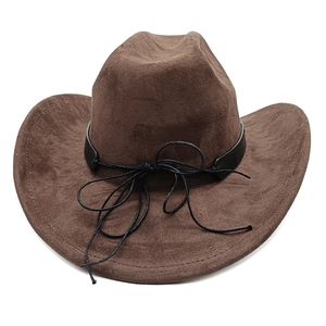 Detail of dark brown suede cowboy hat featuring black leather band and curved brim texture