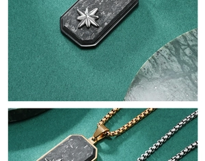 Close-up of forged carbon fiber dog tag pendant with silver hexagram on box chain