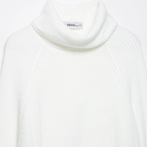 Elegant white high neck knitted sweater with a minimalist ribbed texture and raglan sleeves