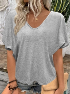 Detailed close-up of grey V-neck T-shirt with batwing sleeves and textured cotton fabric