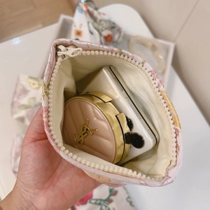 Macro view showing the spacious interior of a floral jacquard mini zipper pouch for storage