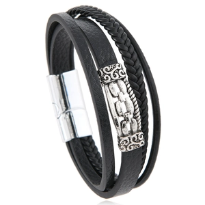 Close-up of multi-layer black braided leather bracelet with silver metal magnetic clasp