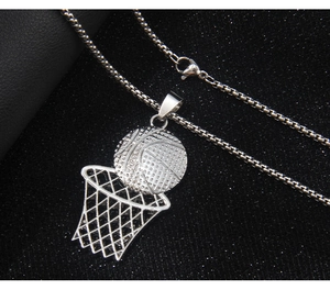 Detailed close-up of a silver stainless steel basketball and hoop pendant on a leather surface