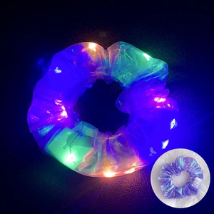 Close-up of LED glowing hair scrunchie with colorful lights in dark and daylight view