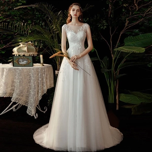 Elegant white A-line wedding dress with floral lace embroidery and sheer mesh neckline