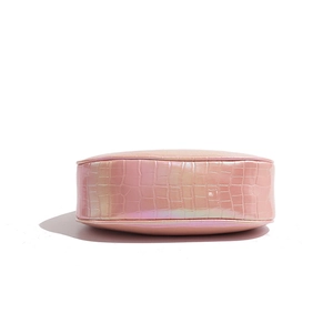 Detailed macro view of pink pearlescent crescent bag showing crocodile leather texture