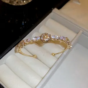 14k gold plated bangle featuring a central rose flower and marquise-cut zircons in a gift box