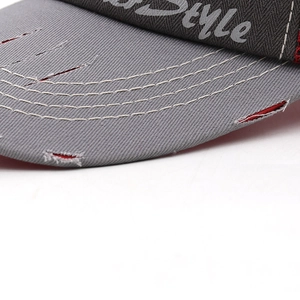 Close-up of vintage washed grey cotton baseball cap with triple stitching and distressed brim