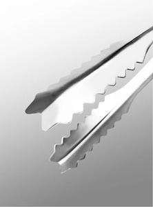 Close-up of stainless steel ice tongs with serrated wavy edges for secure grip
