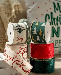 Close-up of festive red and green velvet Christmas ribbons with Merry Christmas prints