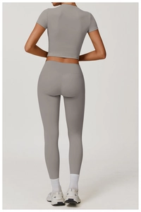 Detail view of charcoal gray two-piece yoga set featuring high-waisted leggings and crop top
