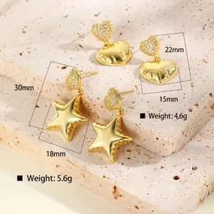 Detailed view of 18K gold plated copper earrings with zircon heart and star shapes