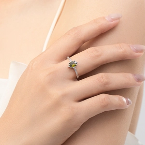 Vintage S925 silver ring featuring an oval olive green gemstone with zirconia accents