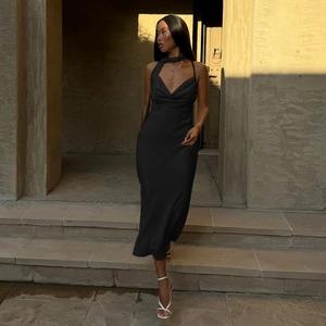 Detail of elegant black satin halter neck midi dress featuring a glossy finish and slim fit