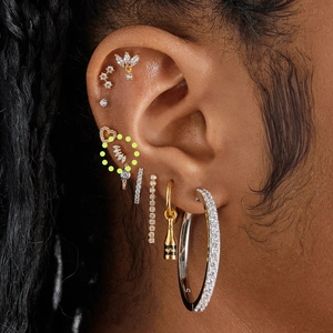 Close-up of S925 silver stud set featuring a triple zircon cluster on the ear