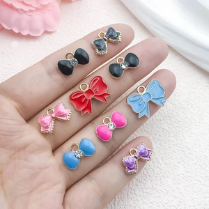 Colorful enamel bow charms in various styles on hand for DIY jewelry making