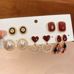 Detailed set of six vintage resin pearl earrings featuring hearts and geometric patterns