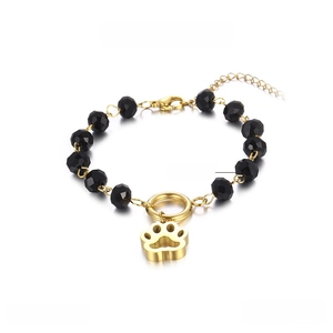 Detail of beaded bracelet showing crystal beads and golden hollow cat paw charm