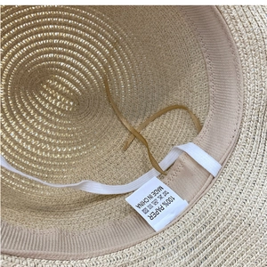 Detail shot of straw hat interior with 100% paper label and adjustable sweatband