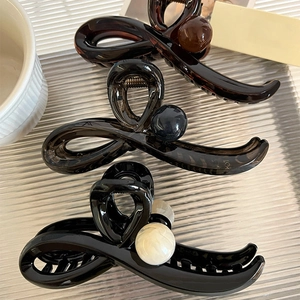 Three-piece set of elegant bow hair claws in tortoise shell, grey, and black finish
