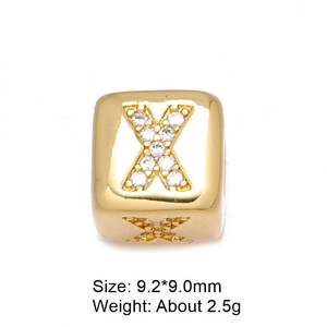 Close-up of golden letter X spacer bead with micro-pave cubic zirconia for DIY jewelry
