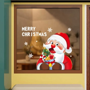 Detail of Santa Claus window stickers with Merry Christmas text on glass surface