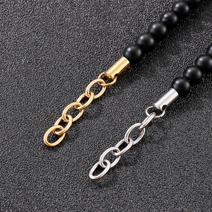 Detail of 6mm matte black agate beads with gold and silver crystal inlaid connectors